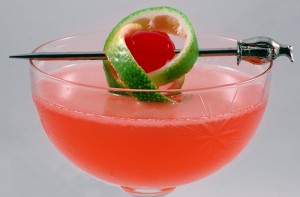Pink_Lady_with_a_twist_of_lime,_in_a_cocktail_glass